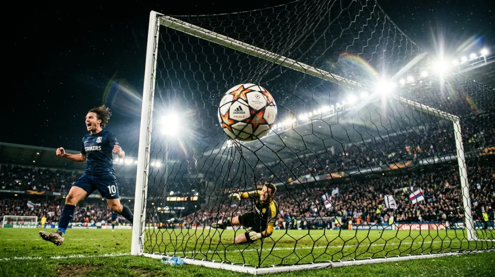 Football goal net close-up with stadium lights